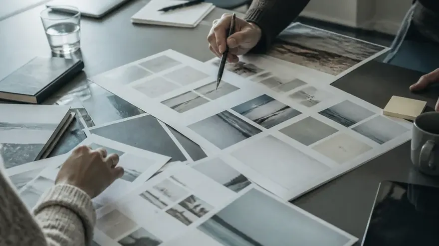An archive room with tall windows and someone working at a table